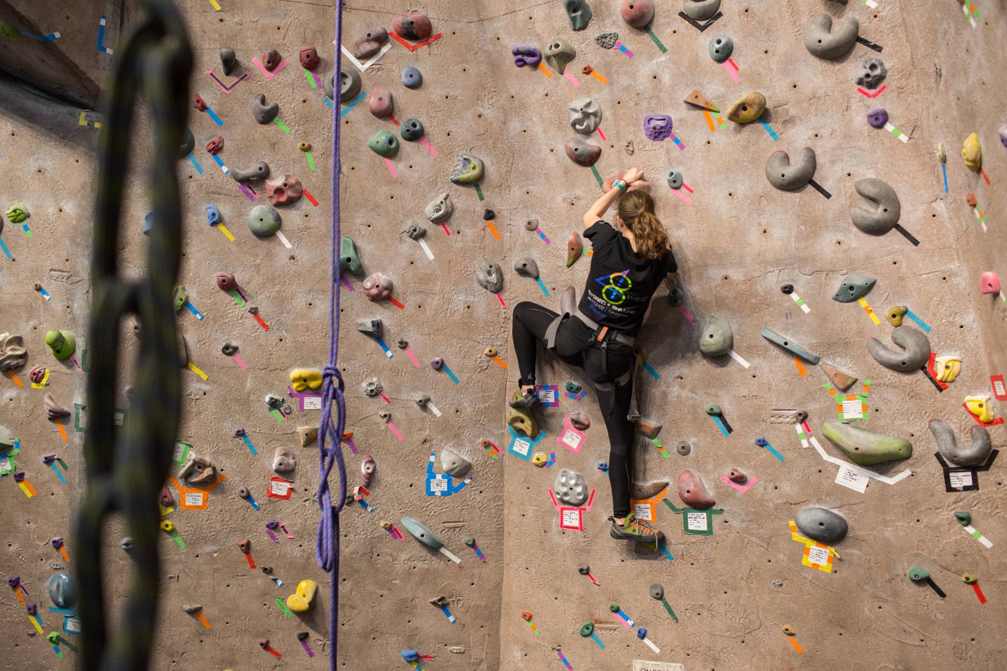 student climbing on rock wall